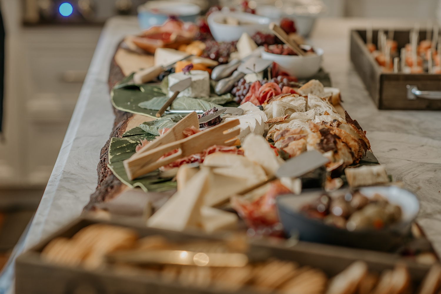 A table topped with a variety of cheeses and crackers.