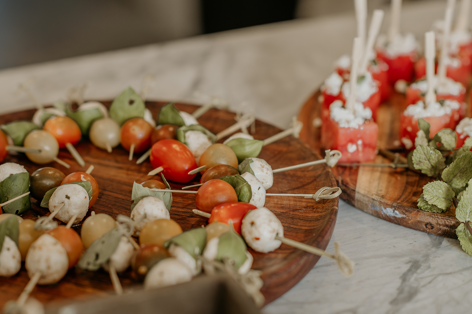 A wooden cutting board topped with a variety of appetizers.