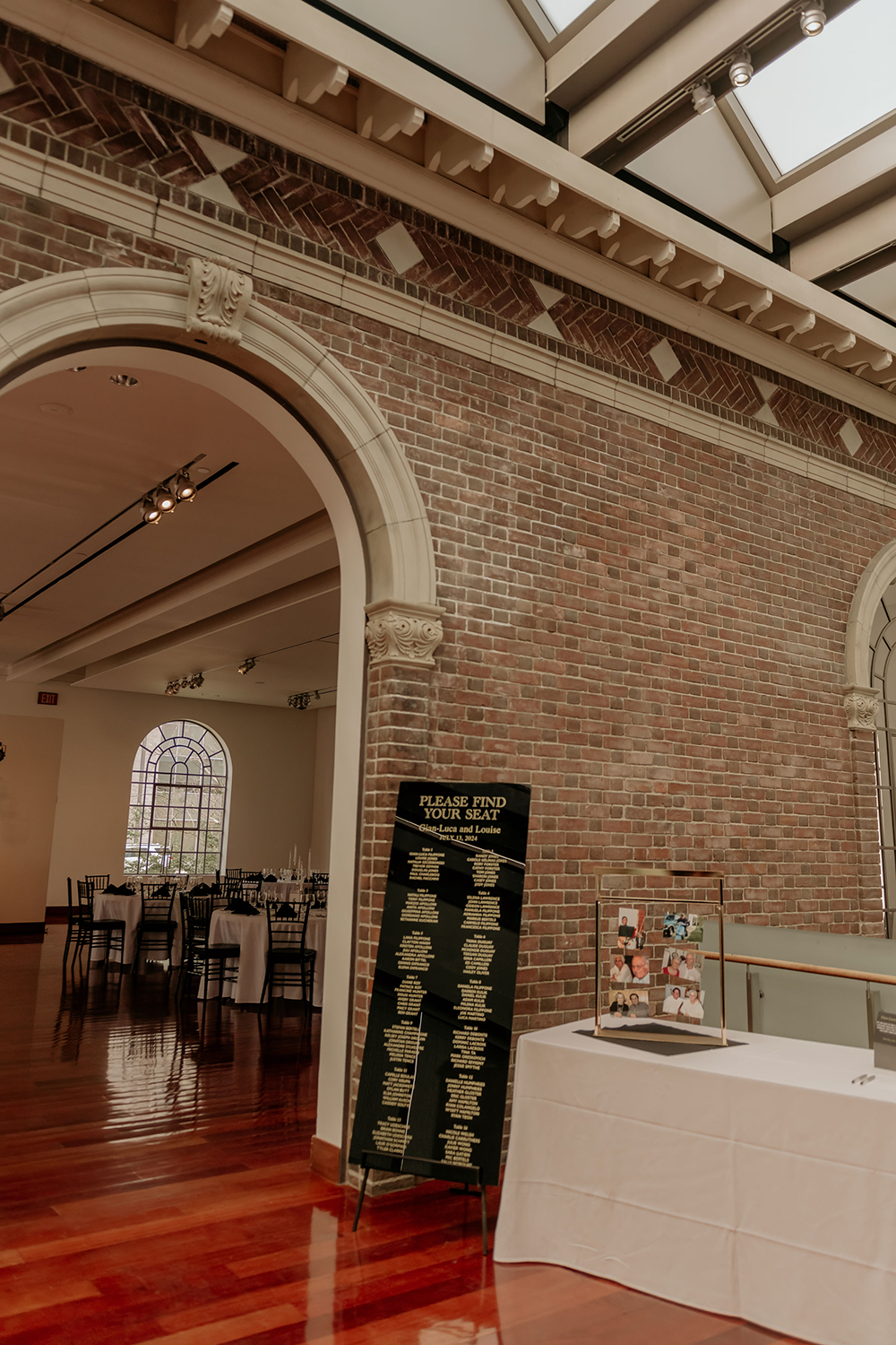 A large room with a brick wall and a white table.