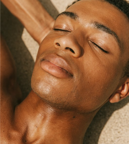 A close up of a man 's face with his eyes closed