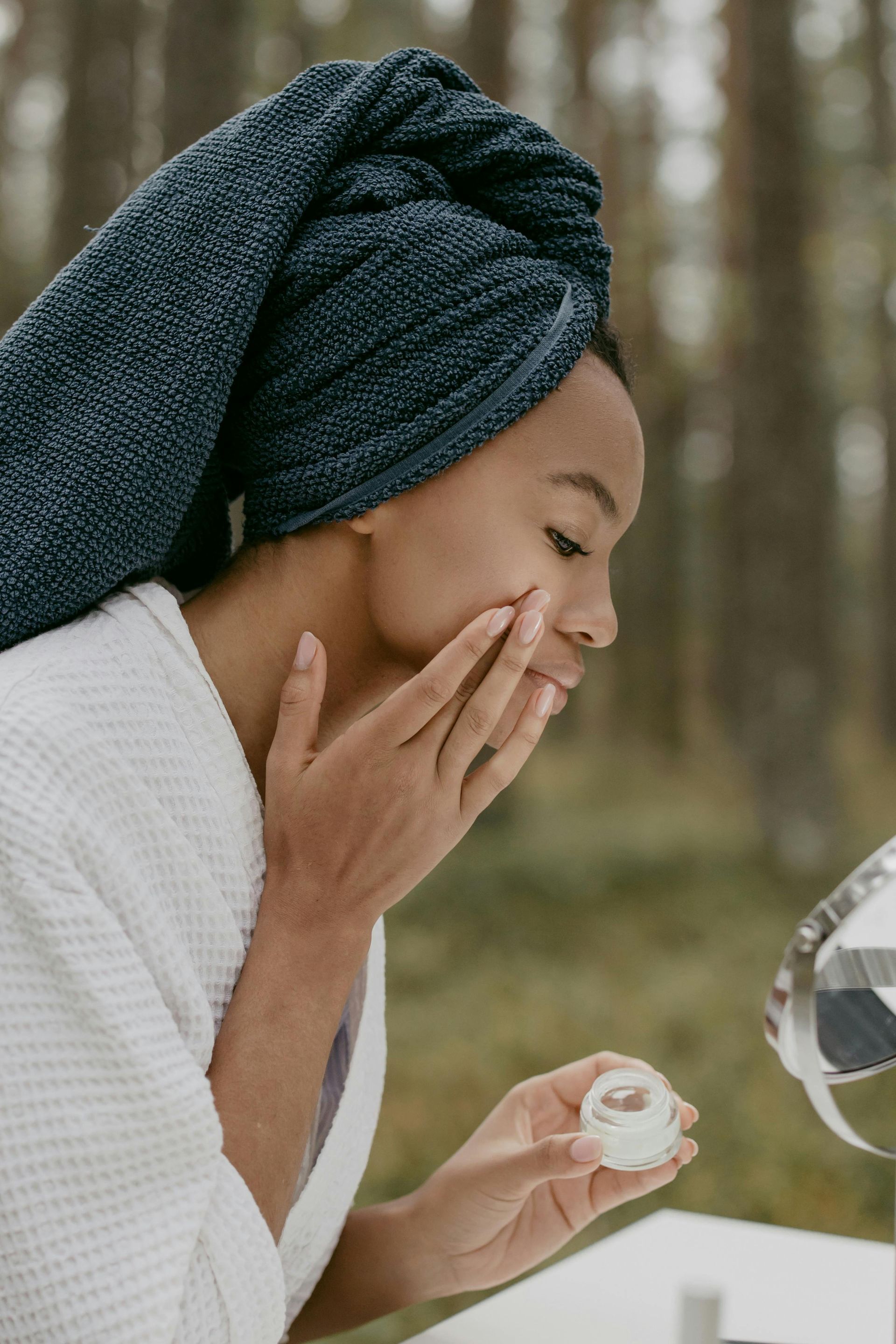 A person is applying a cream to their hand.