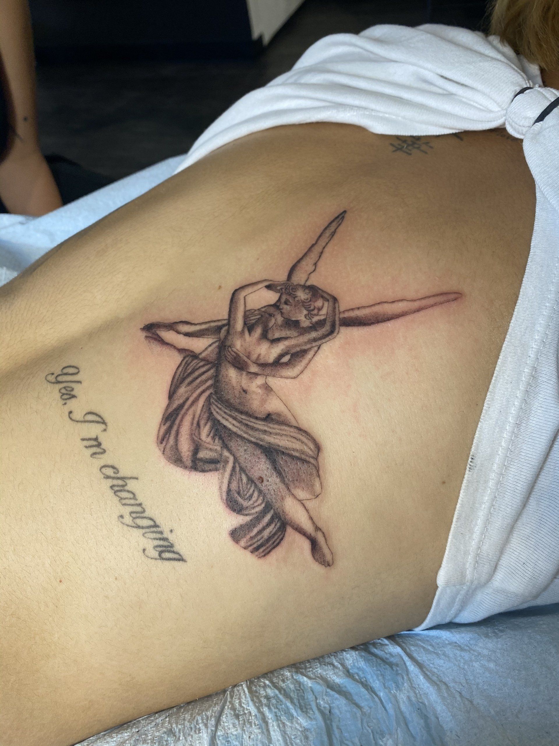 A person with a tattoo on their back that says i 'm changing