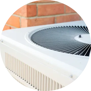 Air conditioning unit against a red brick wall.