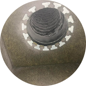 Circular roof vent surrounded by brown insulation, with a metal collar and internal dark vent tube.