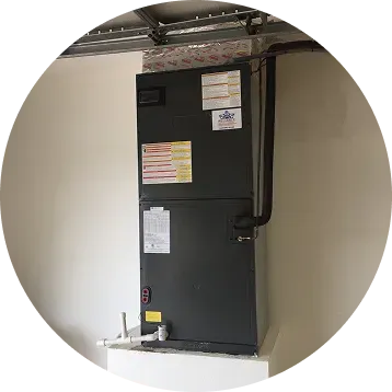 HVAC unit installed in a utility room; black metal with ductwork and piping.