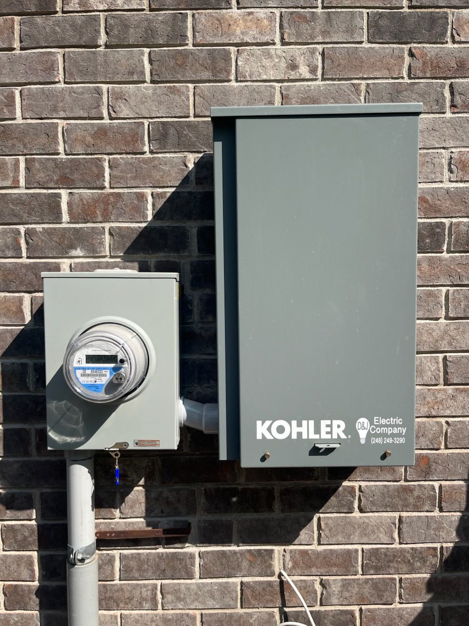 A kohler box is attached to a brick wall