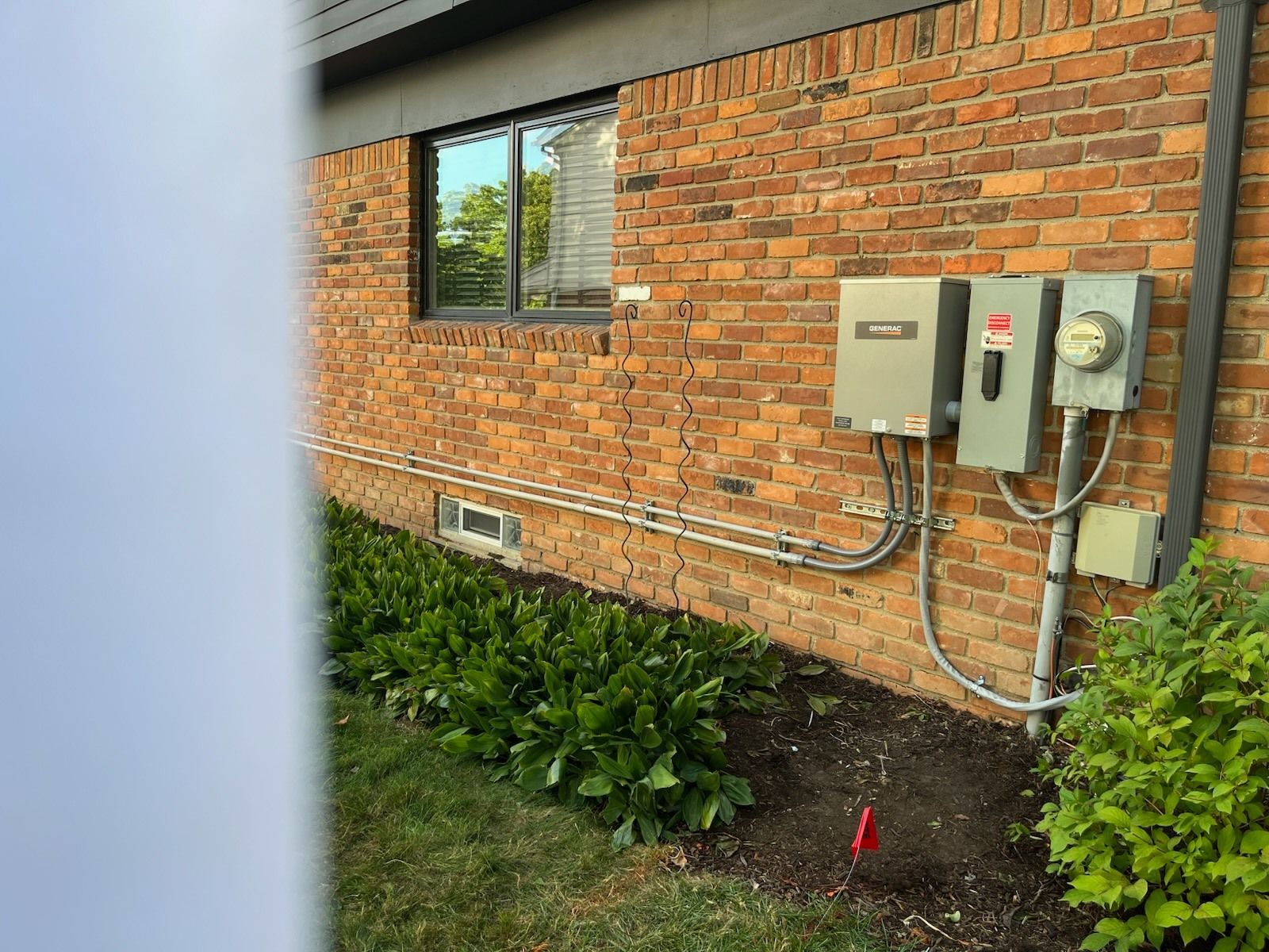 A brick building with electrical boxes on the side of it.