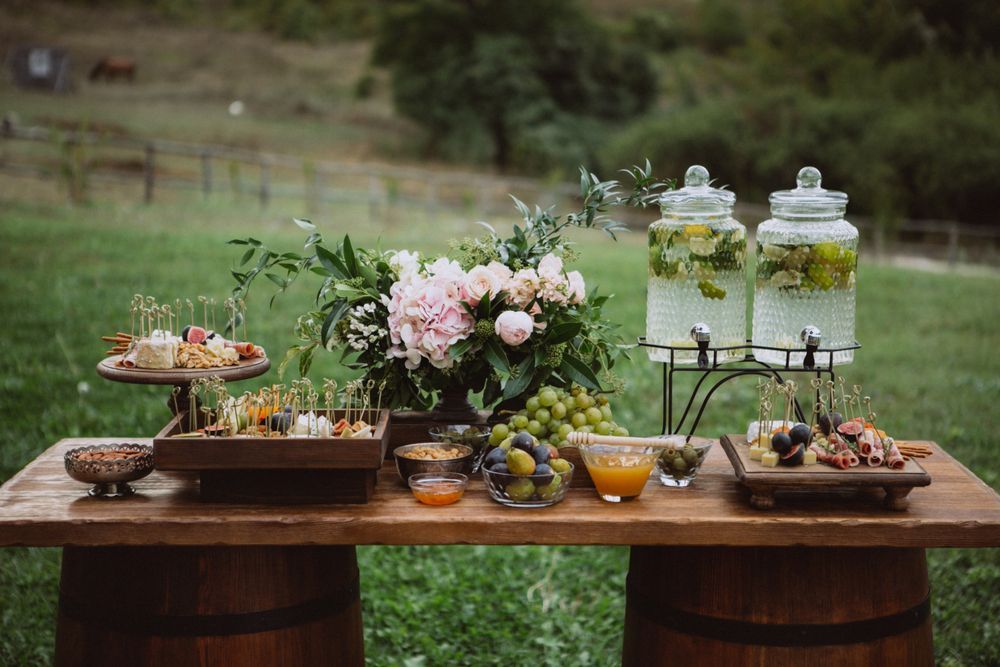 A Wooden Table With a Variety of Food and Drinks Placed on it — Event Hire in Wodonga, NSW