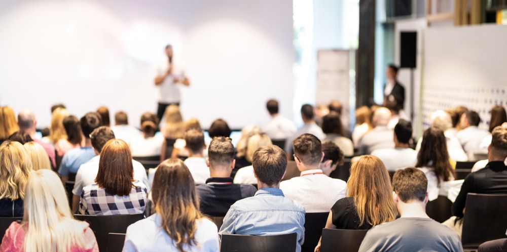 A Large Group of People are Sitting in a Lecture Hall For Conference — Event Hire in Wodonga, NSW
