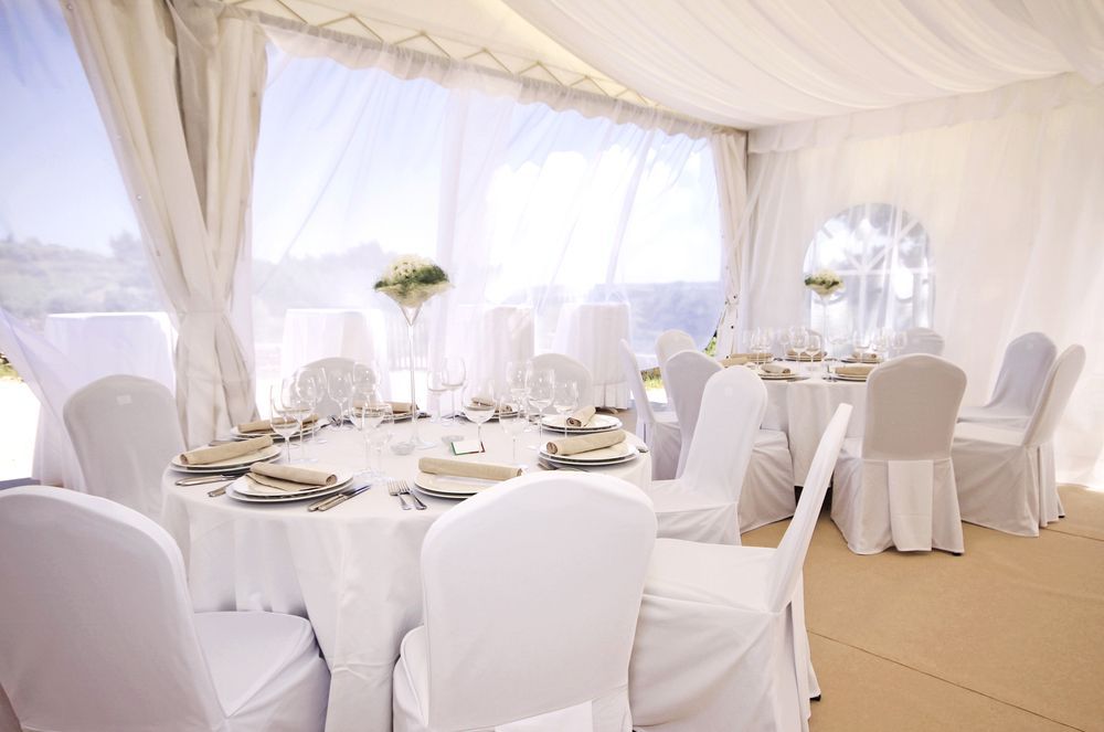 White Chairs at the Wedding Venue in a Tent — Event Hire in Wodonga, NSW