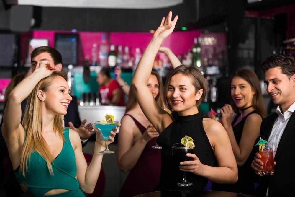 People are Dancing With Cocktails on The Corporate Events — Event Hire in Wodonga, NSW
