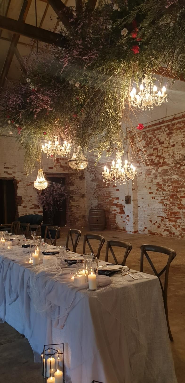 A Long Table With Candles and Chandeliers Hanging From The Ceiling — Event Hire in Wodonga, NSW