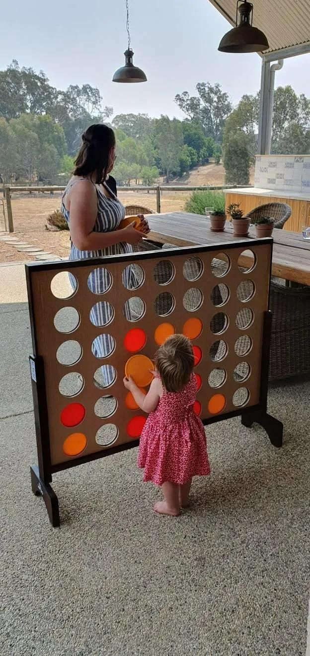 A Woman and a Little Girl are Playing a Game of Connect Four — Event Hire in Wodonga, NSW