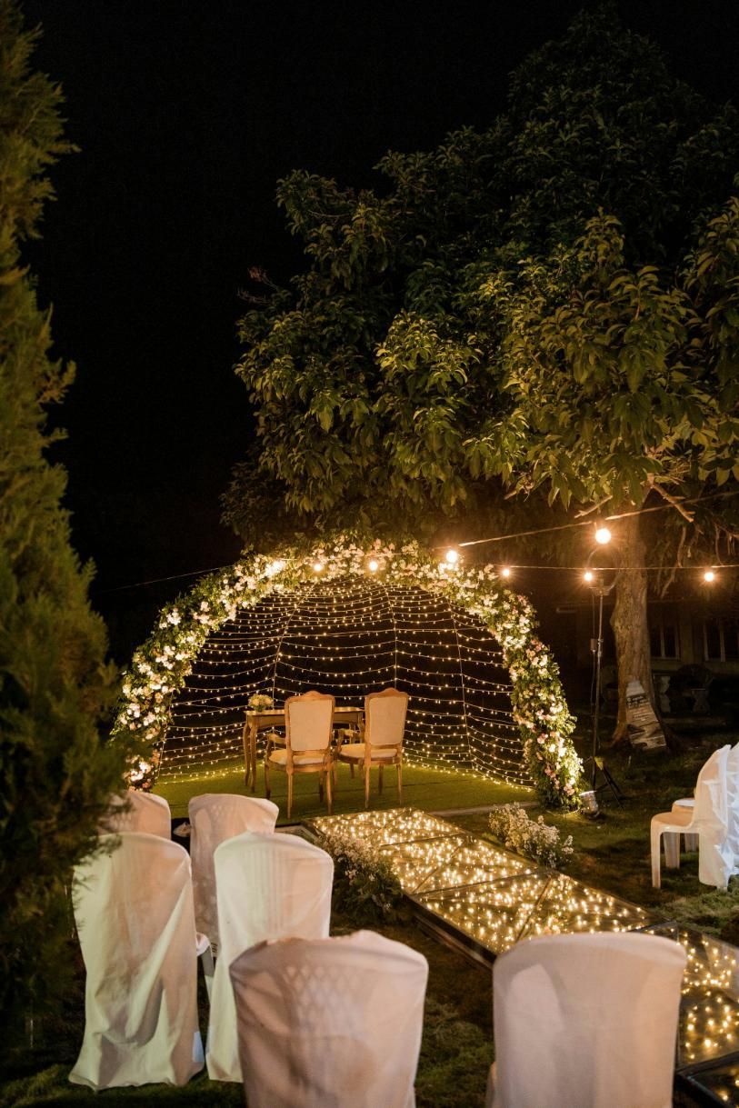 A Wedding Ceremony is Taking Place in a Garden at Night — Event Hire in Wodonga, NSW