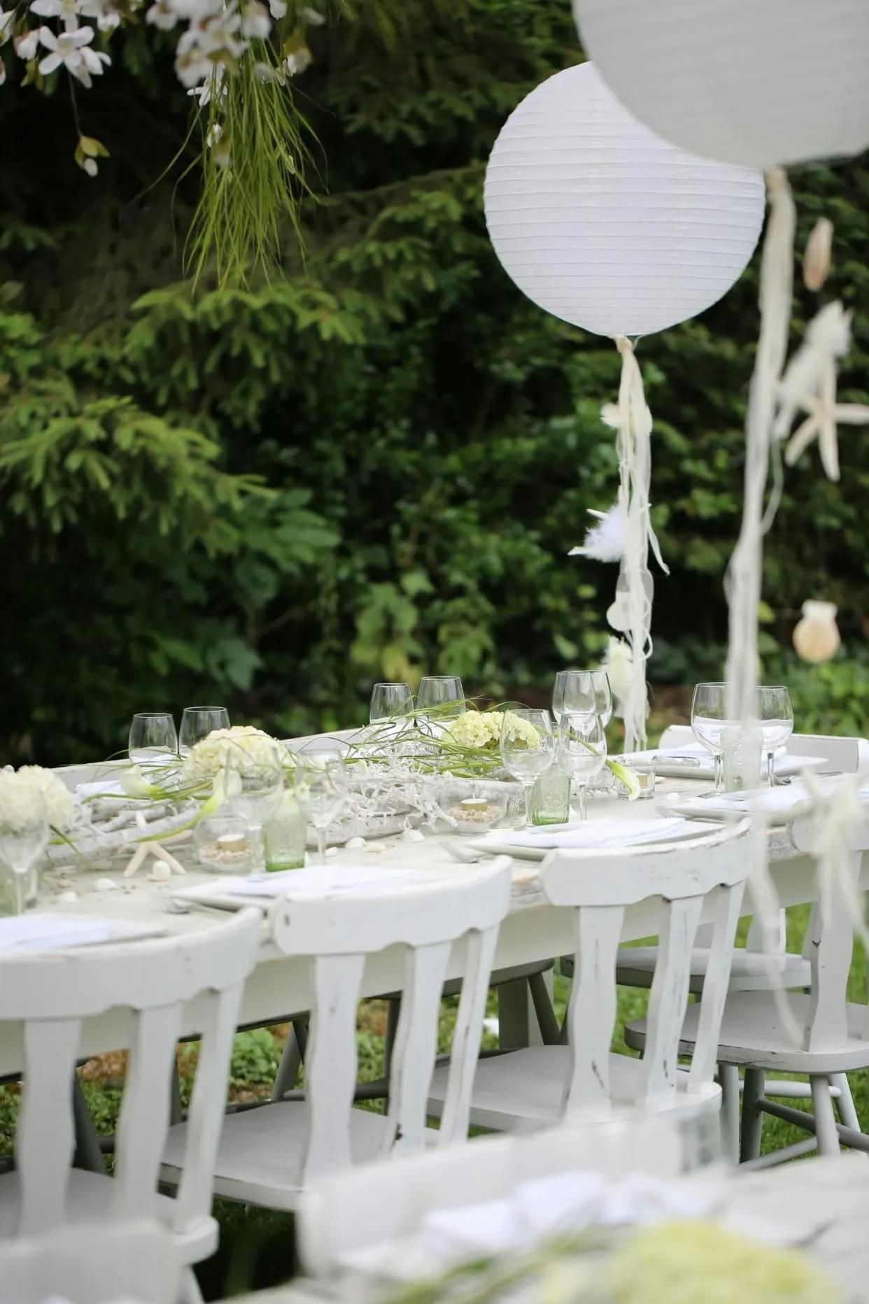 Elegant Wedding Reception Setting with White Chairs and Balloons Adorning the Table — Event Hire in Wodonga, NSW