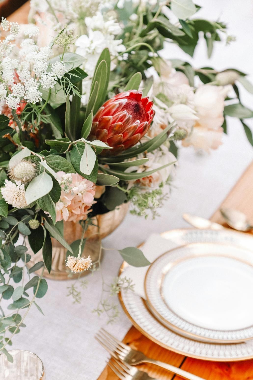 A Table With Plates, Silverware, and a Vase of Flowers on It — Event Hire in Wodonga, NSW