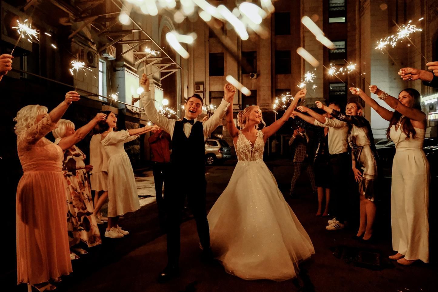 A Bride and Groom are Walking Through a Crowd of People Holding Sparklers — Event Hire in Wodonga, NSW