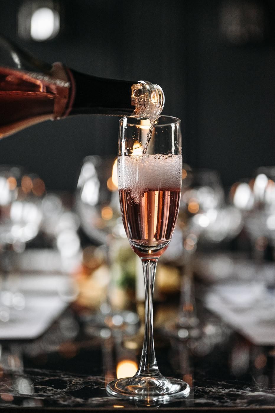 A Person is Pouring Champagne Into a Glass on a Table — Event Hire in Wodonga, NSW
