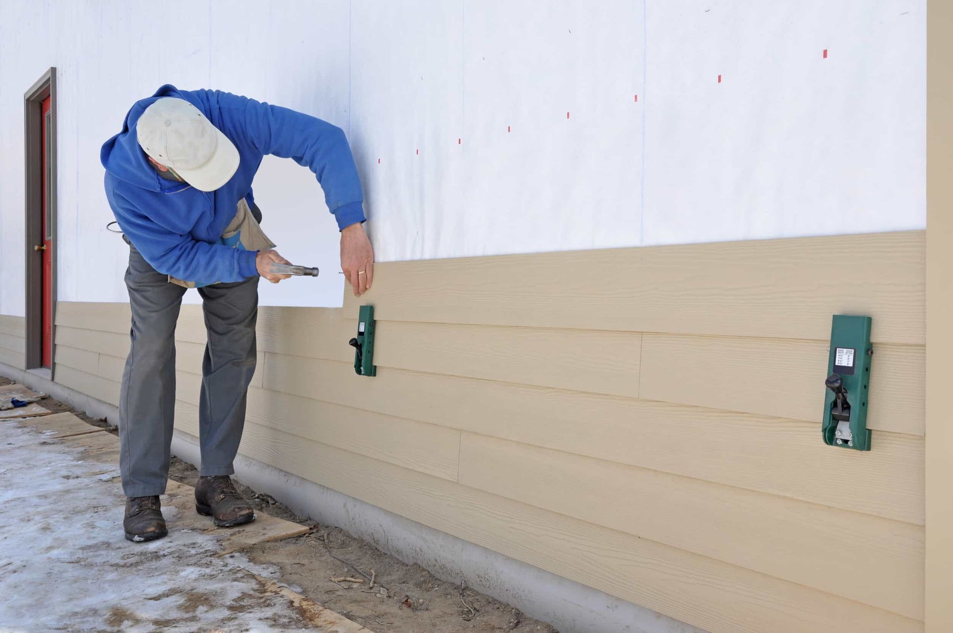 A person is sanding a wooden floor with a machine.