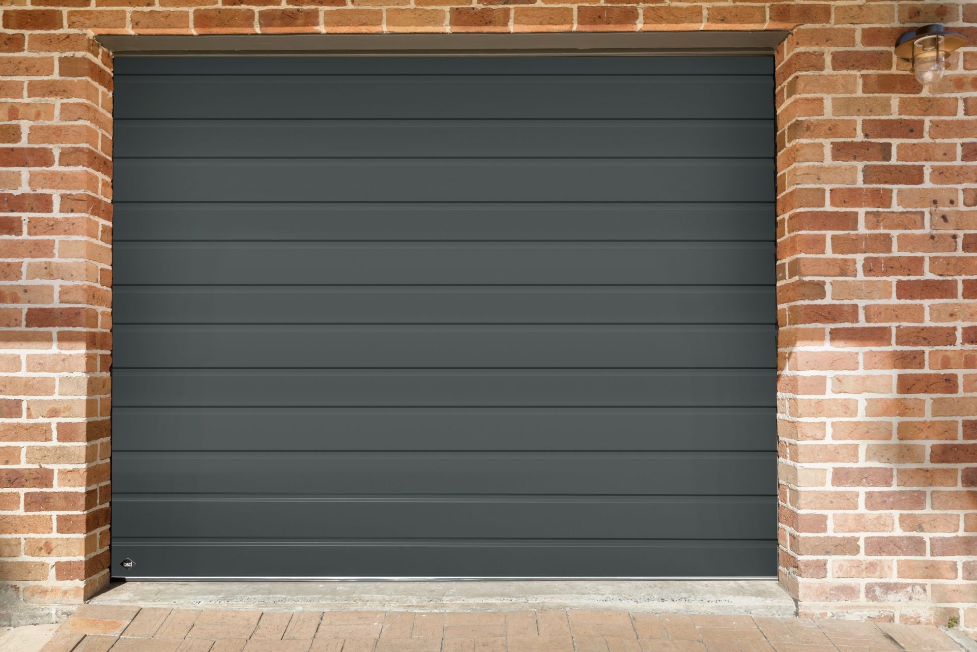 A brick building with a black garage door