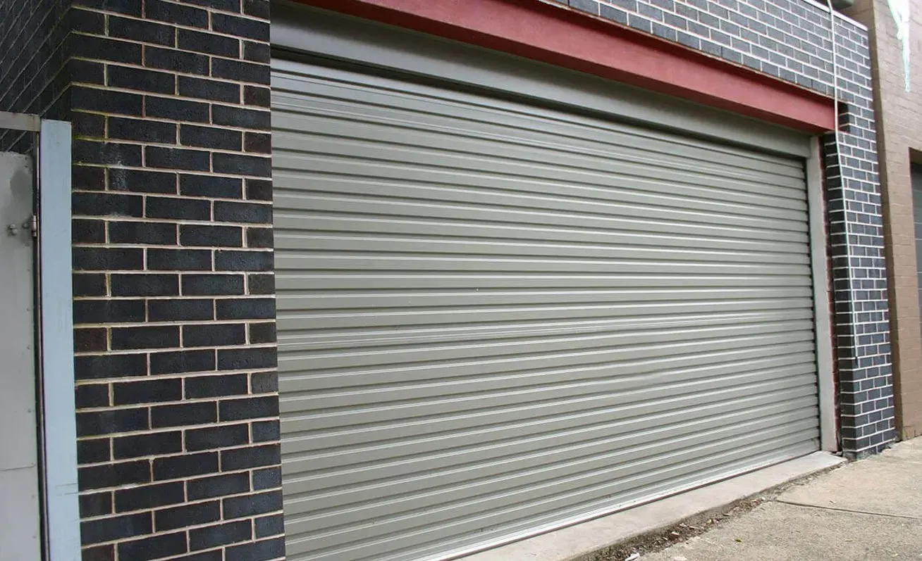 A garage door with a brick wall behind it