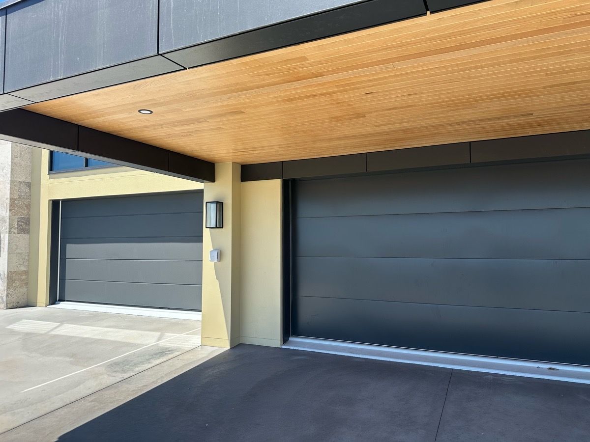 A couple of garage doors with a wooden ceiling