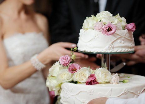 Bride with the freshly baked wedding cake