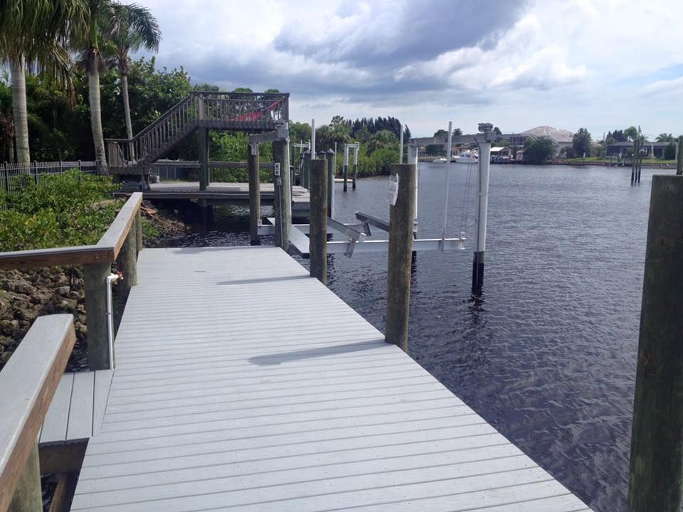Dock with boat lift on a waterway, a cloudy day.