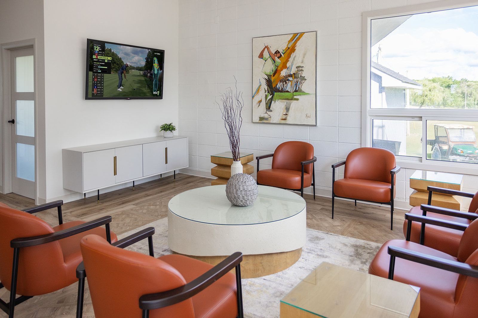 Brock Golf Clubhouse lounge with comfortable seating and warm, inviting design and abstract golf artwork
