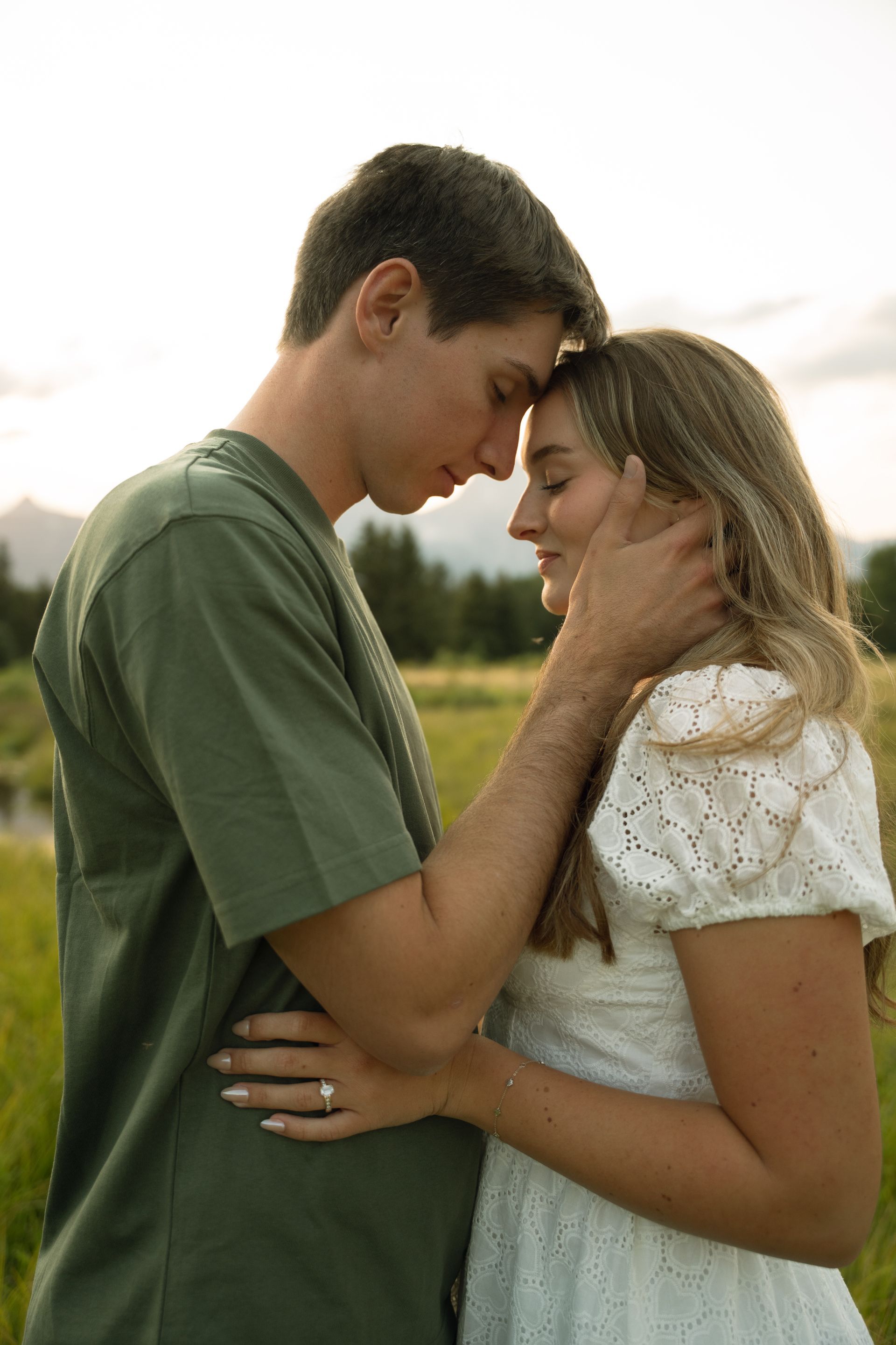 A man in a black shirt is holding a bouquet of yellow daisies