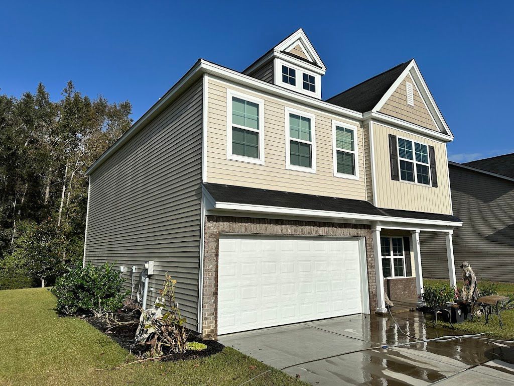 A large house with a white garage door is for sale.