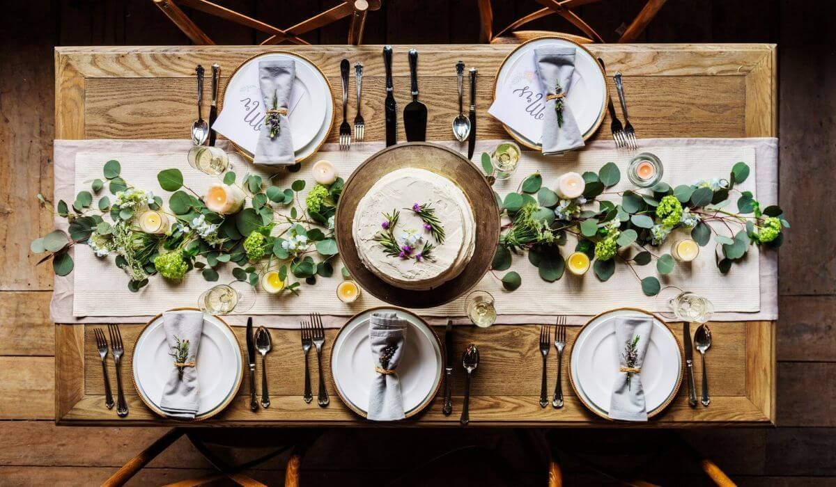 A large table with shared plates in a family-style wedding setting
