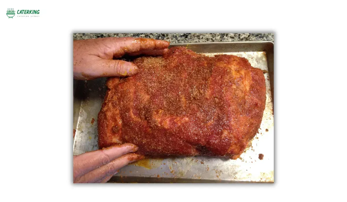 seasoning pork shoulder with dry brine and spice rub before cooking
