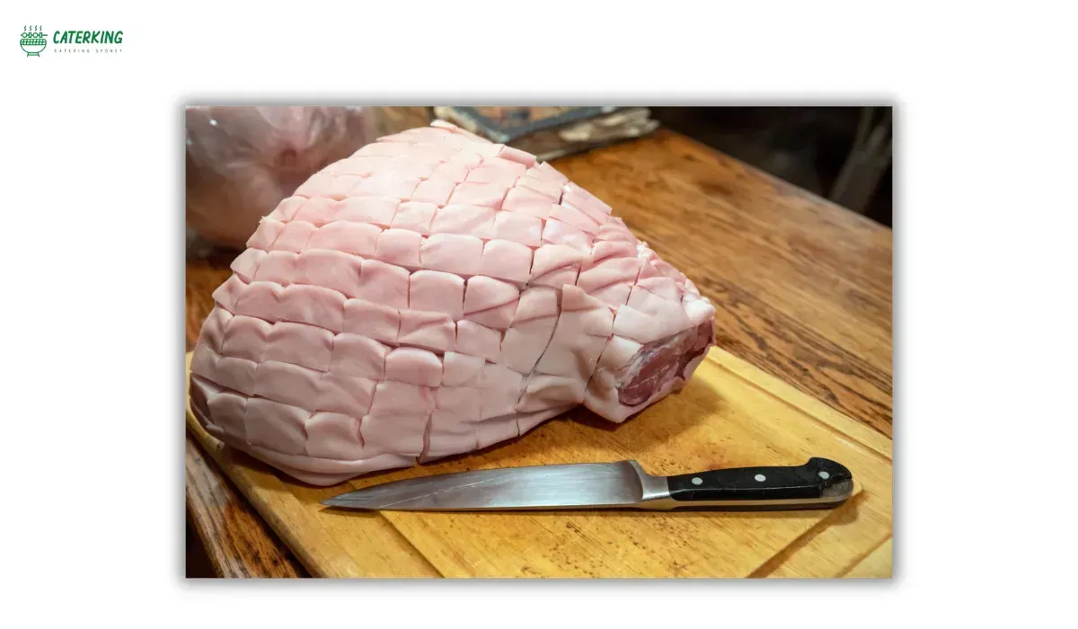 scoring pork skin to allow fat rendering and crackling formation
