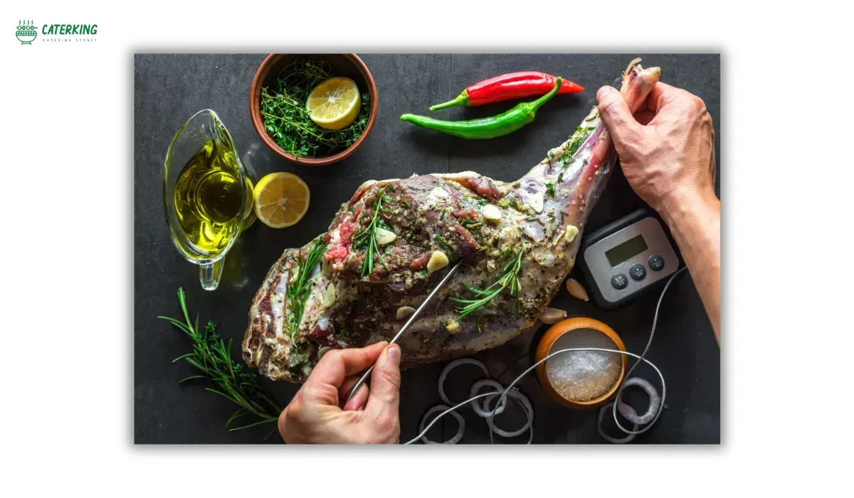 seasoning lamb with garlic herbs and olive oil before spit roasting