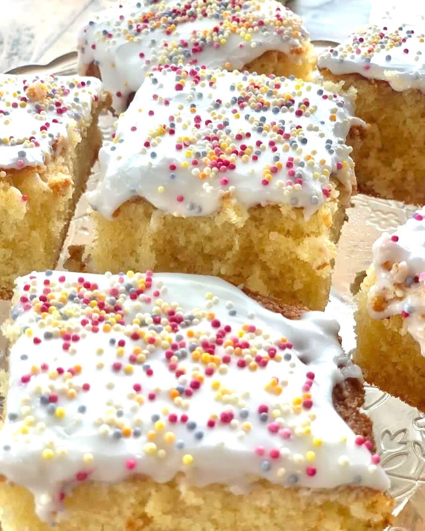 a bunch of cakes with frosting and sprinkles on them