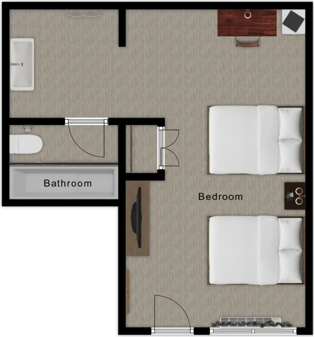 Floor plan of a studio apartment, including a bathroom, bedroom with bed, desk, chair, and TV.