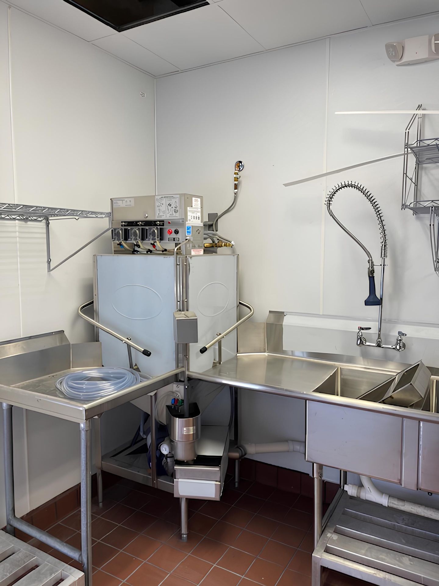 A kitchen with a sink and a dishwasher in it.