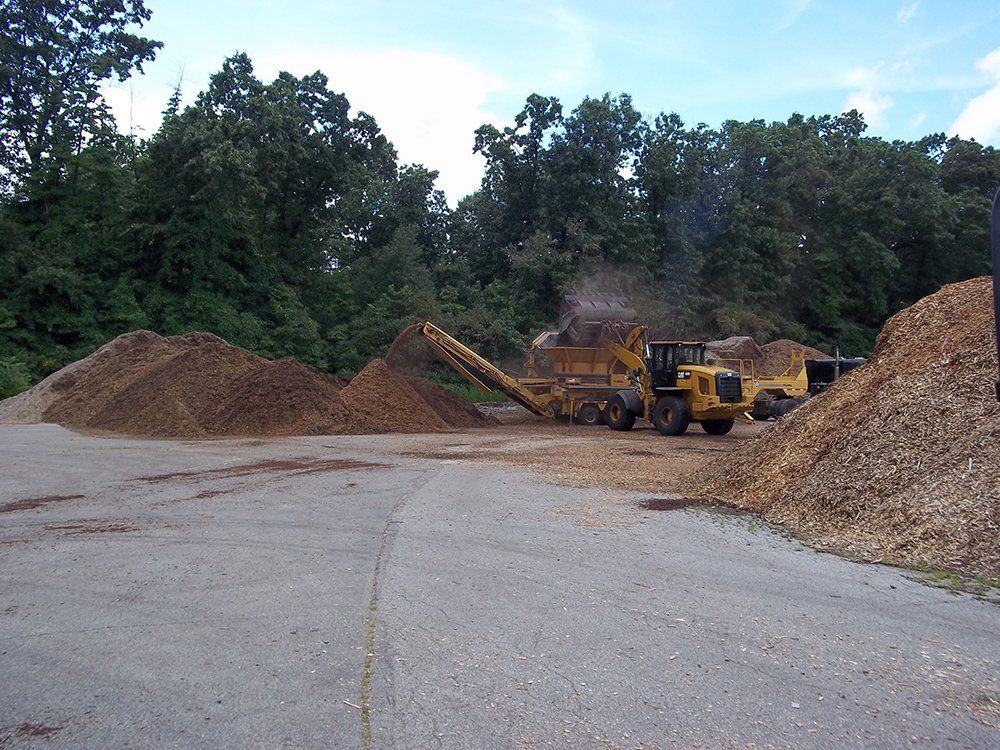 A construction vehicle moving a pile of dirt — Dowagiac, MI — Williams A-1 Expert Tree Service