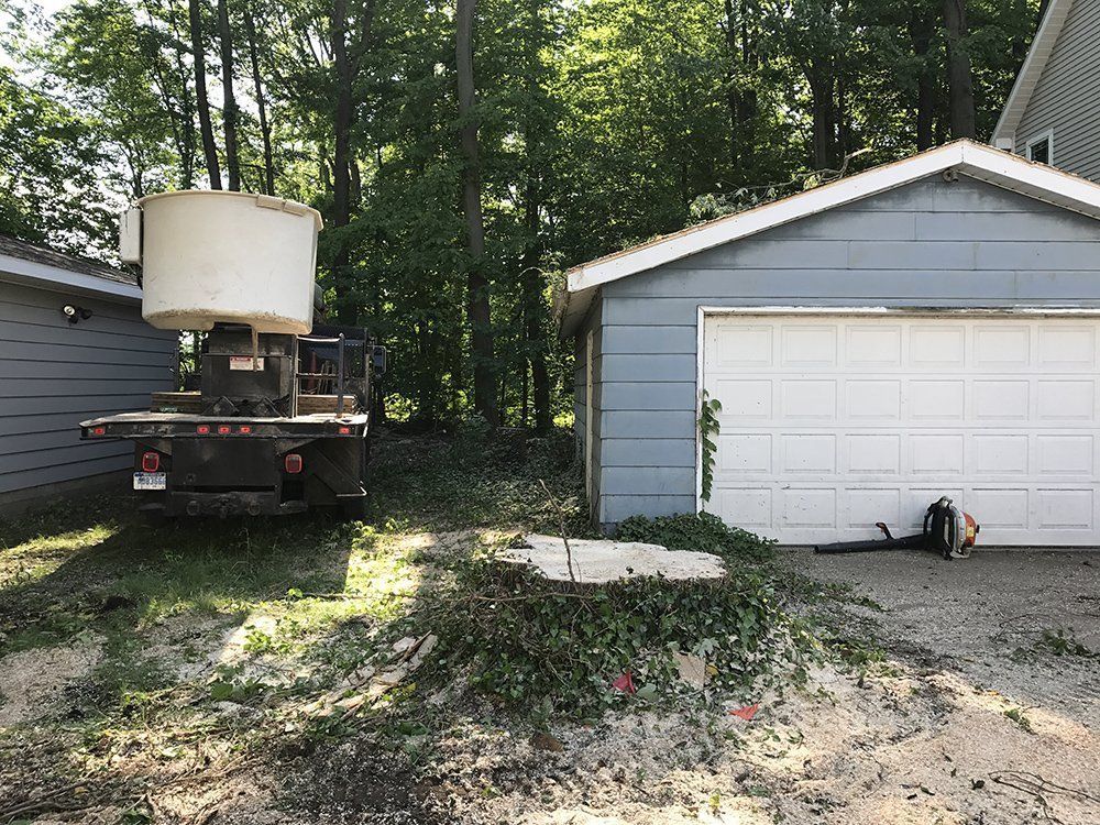 A truck parked beside the garage — Dowagiac, MI — Williams A-1 Expert Tree Service