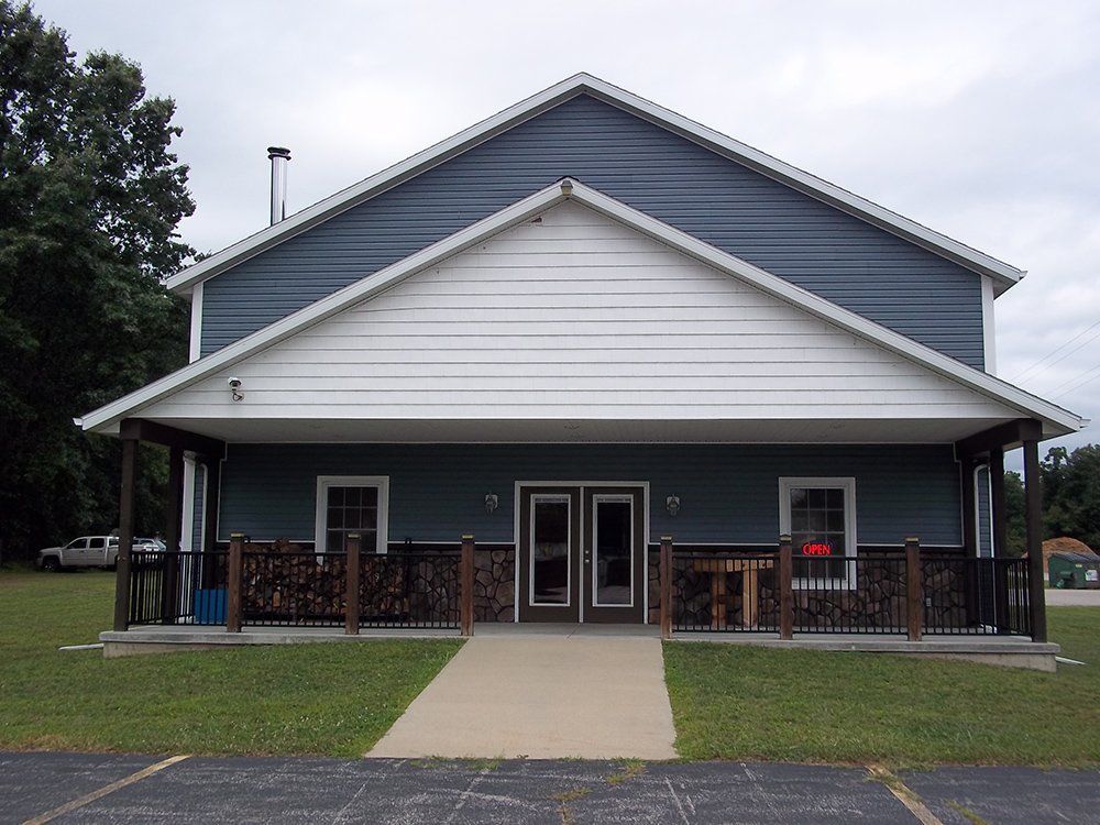 A house with a lawn and a fence in front of it — Dowagiac, MI — Williams A-1 Expert Tree Service