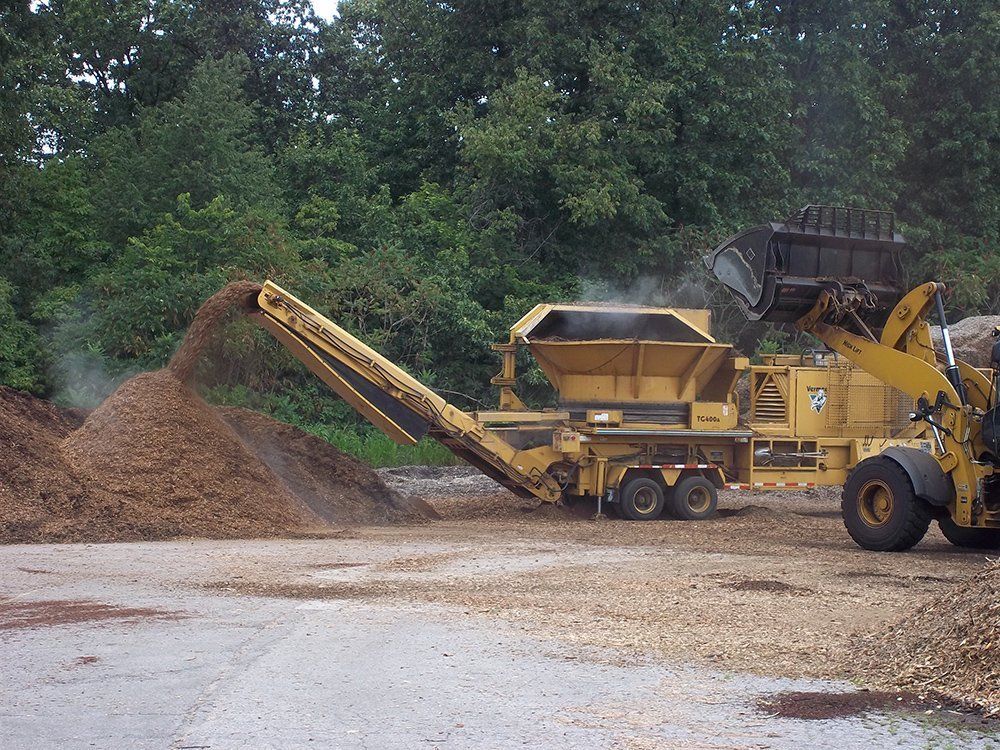 A yellow bulldozer in a dirt field — Dowagiac, MI — Williams A-1 Expert Tree Service