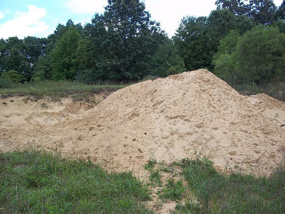 A pile of dirt in a field — Dowagiac, MI — Williams A-1 Expert Tree Service