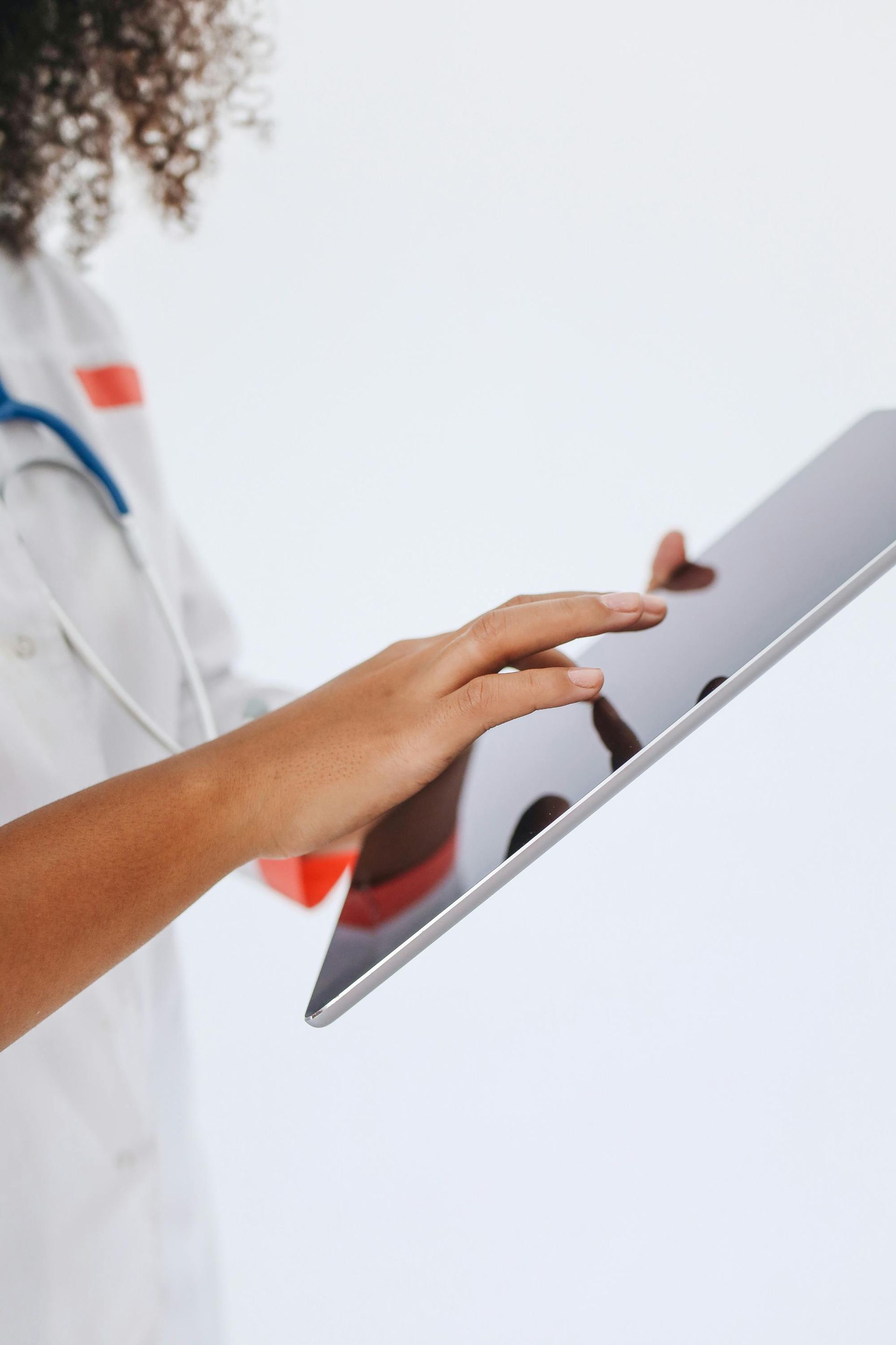 Medical staff reviewing electronic medical records on a tablet.