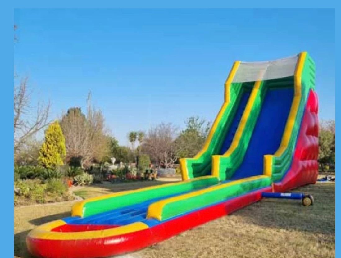A large inflatable water slide is sitting in a park.