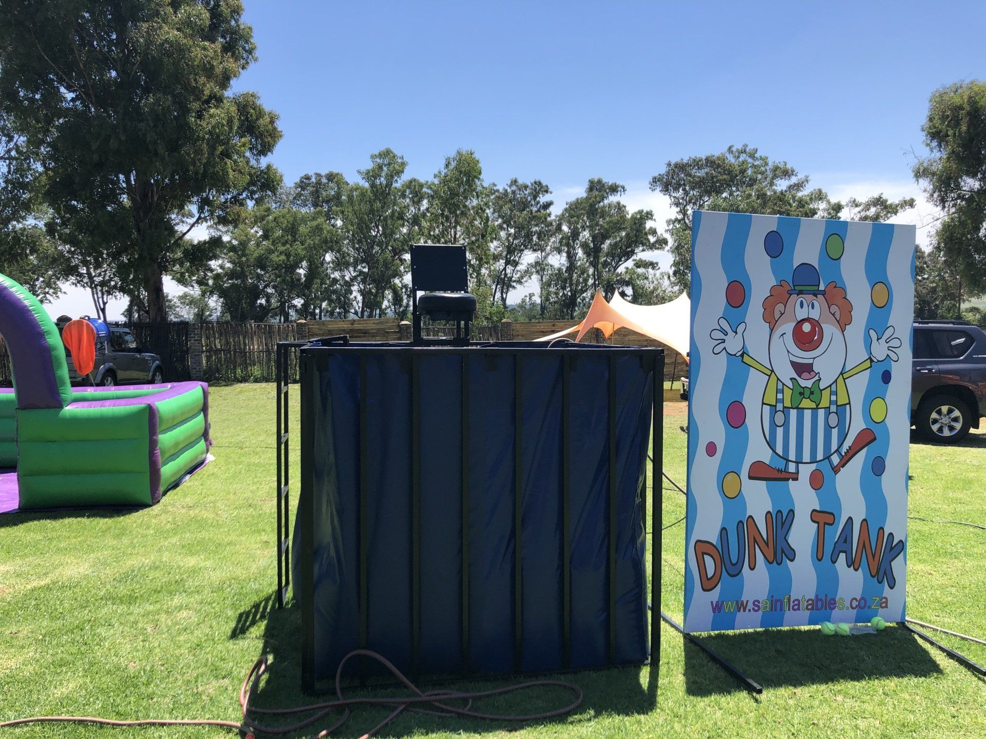 A clown is on a sign that says dunk tank