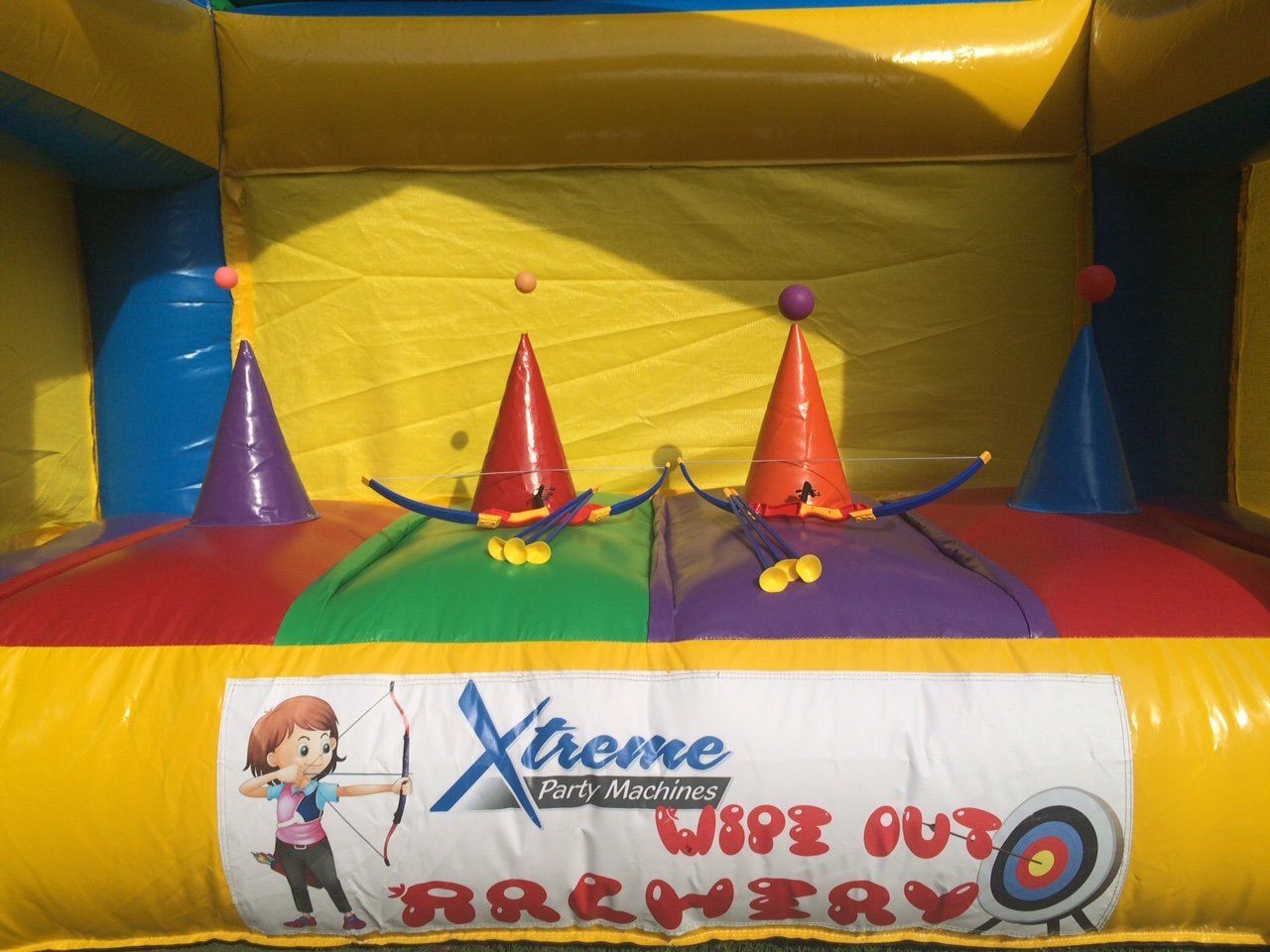 Xtreme wipe out archery is advertised on this bouncy house