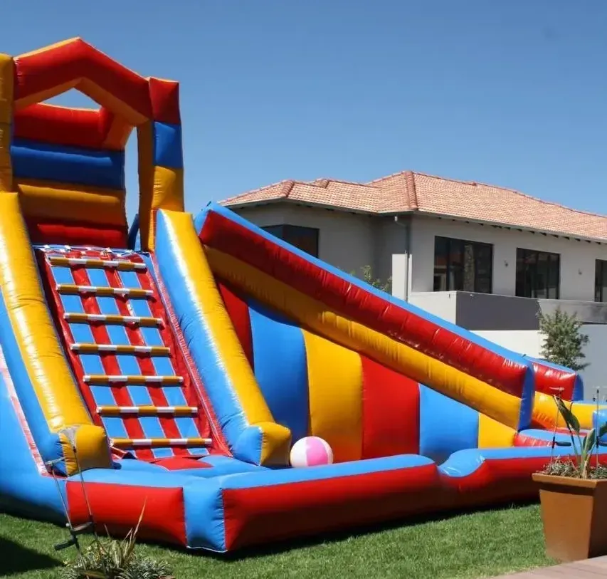 A colorful bouncy house with a slide and stairs