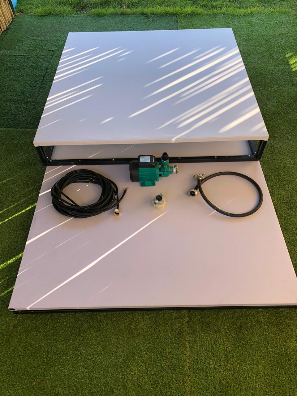 A white table is sitting on top of a green lawn.