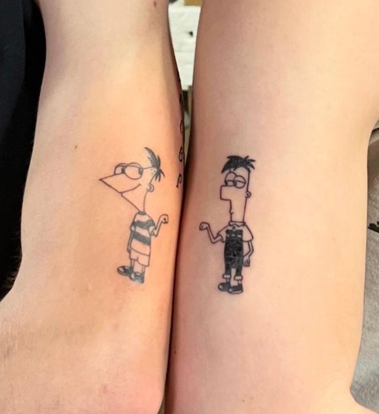 Two matching tattoos of Phineas and Ferb from the cartoon series, on two forearms.